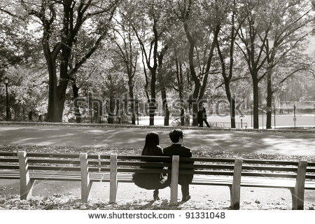 stock-photo-couple-sitting-at-park-bench-91331048